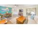 Expansive living area with dining space, wood-style flooring, and access to an outdoor patio or sunroom at 2546 Oakleaf Ln # 35D, Clearwater, FL 33763