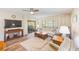 Bright living room with a sliding glass door, wood-style flooring, and a comfortable seating arrangement at 2546 Oakleaf Ln # 35D, Clearwater, FL 33763