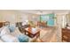 Open-concept living room featuring hardwood floors, an accent wall, and comfortable seating for relaxing and entertaining at 2546 Oakleaf Ln # 35D, Clearwater, FL 33763