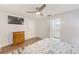 Light bedroom includes ceiling fan, furnishings, and an attached bath/dressing area at 2546 Oakleaf Ln # 35D, Clearwater, FL 33763