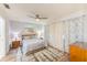 Comfortable bedroom has a ceiling fan, large windows, updated flooring, and stylish furnishings at 2546 Oakleaf Ln # 35D, Clearwater, FL 33763
