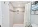 Walk-in shower features light tile, decorative wall niche, and a refreshing shower head at 2546 Oakleaf Ln # 35D, Clearwater, FL 33763