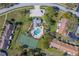 Community aerial view showcasing pool, hot tub, tennis court, parking, and landscaping at 2567 Bentley Dr, Palm Harbor, FL 34684