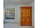 This bedroom features carpet, a wardrobe, and a view of the outside at 2567 Bentley Dr, Palm Harbor, FL 34684
