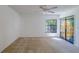 Bright, neutral bedroom featuring a stained glass sliding door at 2567 Bentley Dr, Palm Harbor, FL 34684