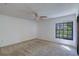Neutral bedroom with a window overlooking the front yard at 2567 Bentley Dr, Palm Harbor, FL 34684