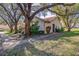 Charming single-story home nestled among mature trees and landscaping at 2567 Bentley Dr, Palm Harbor, FL 34684