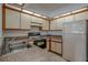 Well-lit kitchen with tile countertops and retro white appliances at 2567 Bentley Dr, Palm Harbor, FL 34684