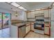 Cozy kitchen features tile countertops and retro white appliances at 2567 Bentley Dr, Palm Harbor, FL 34684