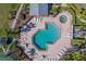 Aerial view of the community pool with lounge chairs and tables for relaxing at 2567 Bentley Dr, Palm Harbor, FL 34684