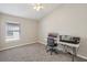 Carpeted bedroom with a ceiling fan, a large window and a desk at 2811 Butterfly Landing Dr, Land O Lakes, FL 34638