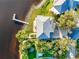 Breathtaking aerial view of a waterfront property featuring lush landscaping, a private dock, and a sparkling pool at 2902 N Shoreview Pl, Tampa, FL 33602