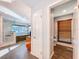 Bright bathroom leading to walk-in shower and toilet room with window and wood blinds at 2902 N Shoreview Pl, Tampa, FL 33602