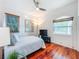 Bright bedroom featuring hardwood floors, a ceiling fan, and plenty of natural light at 2902 N Shoreview Pl, Tampa, FL 33602
