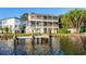 Beautiful waterfront home with a private dock and multiple balconies overlooking the water and lush landscaping at 2902 N Shoreview Pl, Tampa, FL 33602