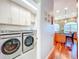 Convenient laundry room adjacent to a modern kitchen with stainless steel appliances and hardwood flooring at 2902 N Shoreview Pl, Tampa, FL 33602