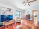 Comfortable living room with ceiling fan, hardwood floors, and a view of the balcony at 2902 N Shoreview Pl, Tampa, FL 33602