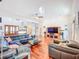Spacious living room featuring hardwood floors, ample seating, and a modern entertainment center at 2902 N Shoreview Pl, Tampa, FL 33602