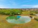A high angle view of a basketball court surrounded by grass and hedges at 5045 Ivory Stone Dr, Wimauma, FL 33598