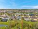 Beautiful aerial view of a well-planned community with single-Gathering homes, surrounded by greenery and bodies of water at 5045 Ivory Stone Dr, Wimauma, FL 33598