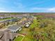 Aerial view of a neighborhood showcasing the layout of the properties, surrounded by trees and water features at 5045 Ivory Stone Dr, Wimauma, FL 33598