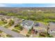 A high angle view of a two-story home with a large driveway and well-maintained landscaping in a suburban neighborhood at 5045 Ivory Stone Dr, Wimauma, FL 33598