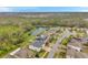 A high angle view showcases suburban homes near a pond and nature preserve at 5045 Ivory Stone Dr, Wimauma, FL 33598