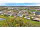 Beautiful aerial view of a well-planned community with single-Gathering homes, surrounded by greenery and bodies of water at 5045 Ivory Stone Dr, Wimauma, FL 33598