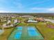 A high angle view showcases tennis courts, a pool, and a playground in a community setting at 5045 Ivory Stone Dr, Wimauma, FL 33598