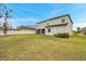 A home with a beautiful fenced backyard and a well-maintained lawn, perfect for outdoor activities at 5045 Ivory Stone Dr, Wimauma, FL 33598