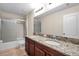 Bathroom boasts double sinks with granite countertop, a shower-tub combination and tile floors at 5045 Ivory Stone Dr, Wimauma, FL 33598