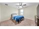 Bedroom with neutral carpet, ceiling fan, window, and dresser at 5045 Ivory Stone Dr, Wimauma, FL 33598