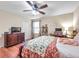 Bedroom features ceiling fan, a window, a large dresser, and space for a desk and storage at 5045 Ivory Stone Dr, Wimauma, FL 33598