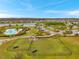 Aerial view highlights the community park, dog park, pool and tennis courts at 5045 Ivory Stone Dr, Wimauma, FL 33598