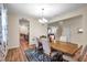 Dining room with wood floors features a chandelier and a large window with curtains at 5045 Ivory Stone Dr, Wimauma, FL 33598