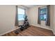 Well-lit exercise room features wood floors, a large window, and an elliptical for a convenient workout space at 5045 Ivory Stone Dr, Wimauma, FL 33598