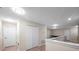Hallway with tile floors, doors, and white walls, connecting different parts of the house at 5045 Ivory Stone Dr, Wimauma, FL 33598
