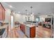 Open-concept kitchen with granite countertops, stainless steel appliances, and a pantry with a wooden door at 5045 Ivory Stone Dr, Wimauma, FL 33598