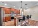 Bright kitchen features wood cabinets, stainless steel appliances, granite countertops, and a breakfast bar with seating at 5045 Ivory Stone Dr, Wimauma, FL 33598