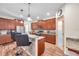 Bright kitchen features wood cabinets, stainless steel appliances, granite countertops, and a frosted pantry door at 5045 Ivory Stone Dr, Wimauma, FL 33598