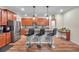 Modern kitchen featuring stainless steel appliances, granite countertops, island with seating, and wood cabinets at 5045 Ivory Stone Dr, Wimauma, FL 33598
