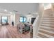 Hardwood floors lead from the home's staircase to this beautiful living room with sliding glass door access at 5045 Ivory Stone Dr, Wimauma, FL 33598