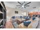 Comfortable living room with hardwood floors, a ceiling fan, a large sectional, and stylish decor at 5045 Ivory Stone Dr, Wimauma, FL 33598