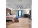 Spacious main bedroom with a ceiling fan, accent wall, light wood floors, and plenty of natural light at 5045 Ivory Stone Dr, Wimauma, FL 33598