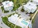 Aerial view of condo building, pool, parking, and landscaping at 7611 34Th W Ave # 303, Bradenton, FL 34209