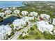 Beautiful aerial view of the condo complex near a lake with multiple buildings and lush greenery at 7611 34Th W Ave # 303, Bradenton, FL 34209