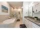 Bright primary bathroom with soaking tub, walk-in shower, and double vanity at 7611 34Th W Ave # 303, Bradenton, FL 34209