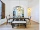 Dining room featuring high ceilings, stylish lighting, elegant decor, and wood flooring at 26848 Shoregrass Dr, Wesley Chapel, FL 33544