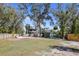 The backyard features a green lawn, trees, and a wooden fence at 3087 Duane Ave, Oldsmar, FL 34677