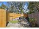 Large backyard with wood fence, picnic table, and fire pit, ideal for outdoor activities at 3087 Duane Ave, Oldsmar, FL 34677